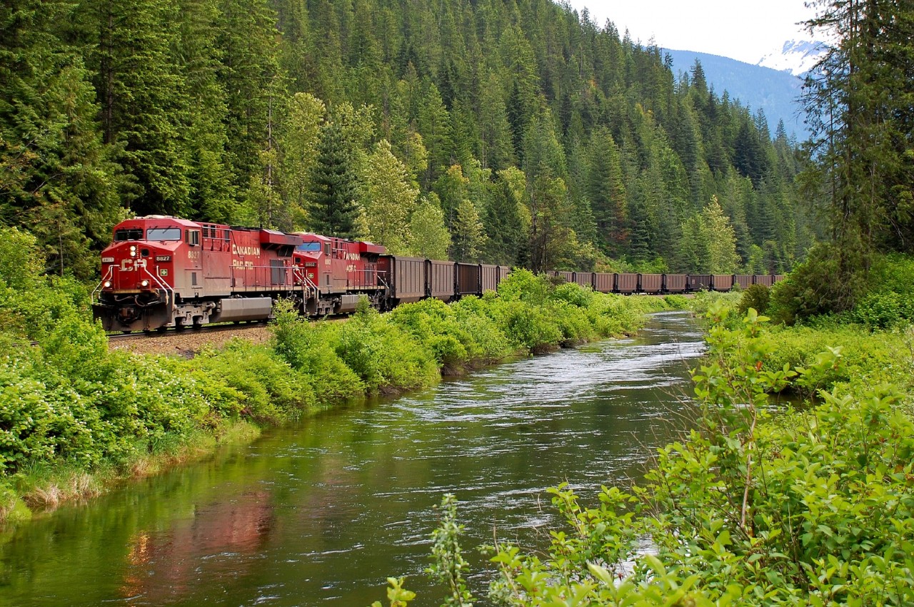 A westbound coal train is winding through the "Enchanted Forest" behind CP nos.8827&8862.