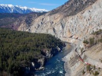 There have been a lot of shots taken at this location in the Thompson canyon, but when the weather is this good it's hard to resist taking another one. CP 9775 is leading a westbound load of grain through the rock sheds and in the distance the snow capped mountains mark the west side of the Fraser valley.