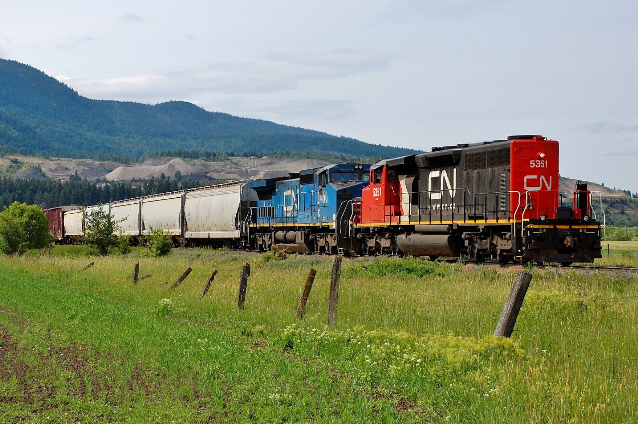 An interesting lash-up with CN 5351 running long hood forward in combination with a rare visitor IC 2460. This mixed freight is about to depart from the outskirts of Armstrong and head north to Kamloops.