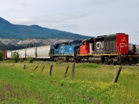 An interesting lash-up with CN 5351 running long hood forward in combination with a rare visitor IC 2460. This mixed freight is about to depart from the outskirts of Armstrong and head north to Kamloops.
