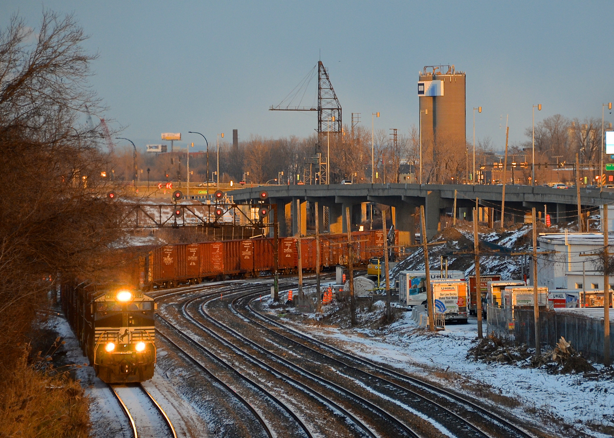 NS 7698 leads a short CN 529 on the transfer track of CN's Montreal Sub not too long before sunset.