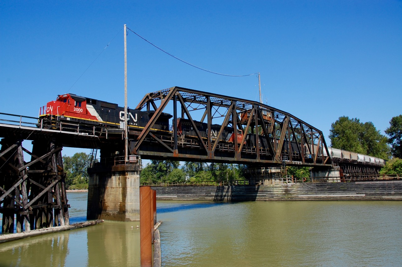 CN nos.2000&5662 are crossing the Fraser River on the Lulu Island bridge at the head of a westbound mixed freight.