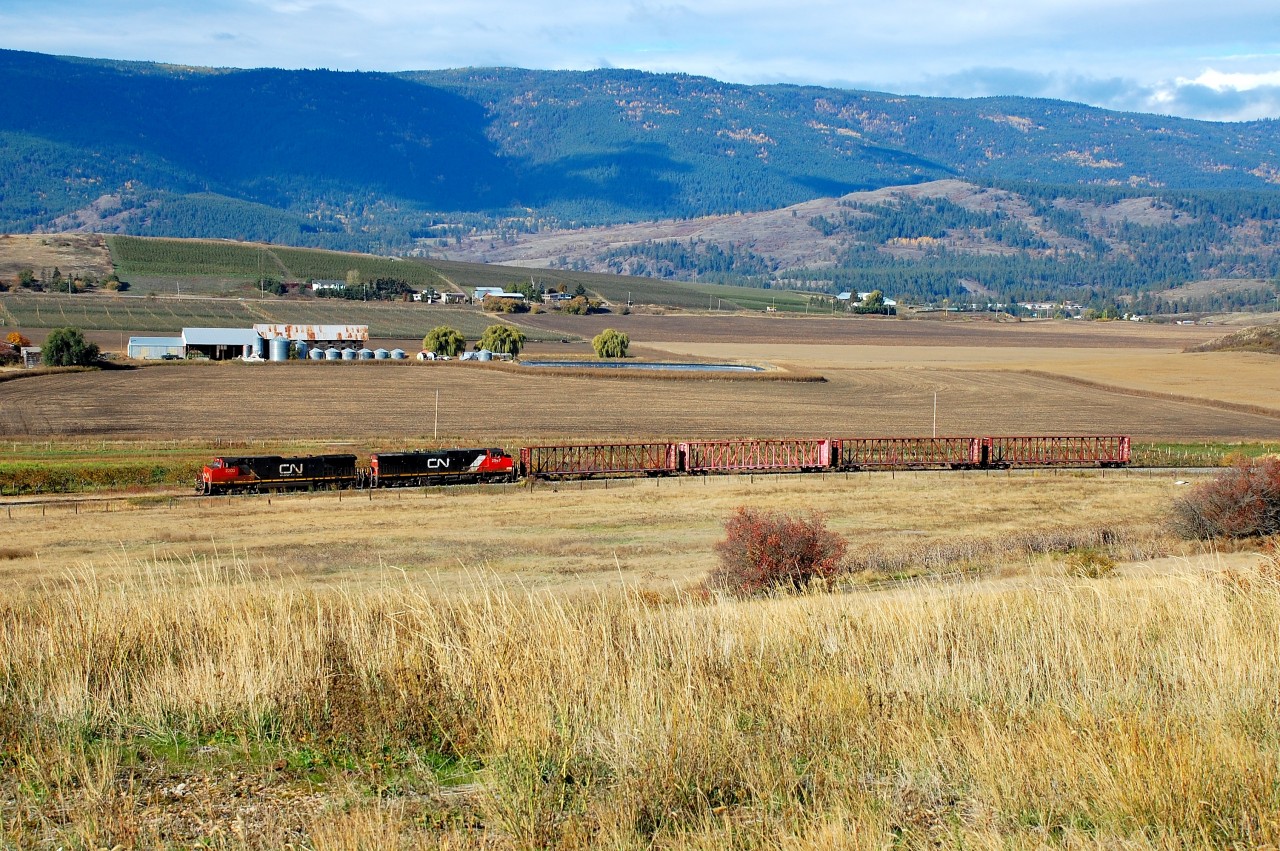After dropping some hopper cars at the Larkin siding, CN nos.2203&2567 are heading south towards Vernon with just four center beams in tow.