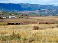 After dropping some hopper cars at the Larkin siding, CN nos.2203&2567 are heading south towards Vernon with just four center beams in tow.