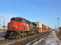 CN 2282 is shoving on the rear of CN 106 which is passing VIA's Dorval Station on a sunny winter afternoon. 