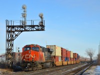 CN 2282 is shoving on the rear of CN 106 which is passing VIA's Dorval Station on a sunny winter afternoon. 