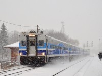 Cab car AMT 701 kicks up the snow as it passes southbound through Lasalle station on a snowy morning. It is deadheading on its way to the South Shore to pick up more commuters to bring to Montreal.