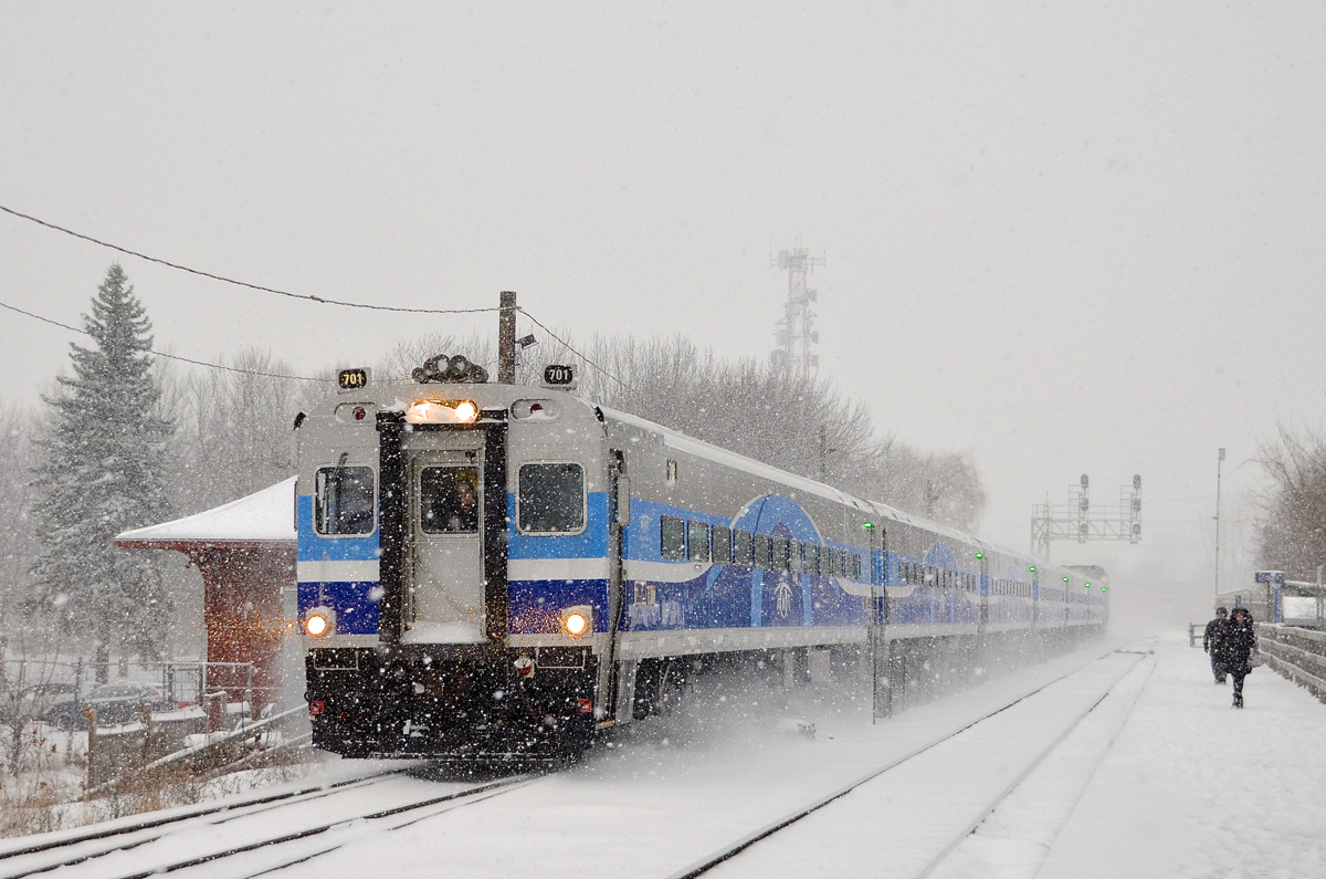 Cab car AMT 701 kicks up the snow as it passes southbound through Lasalle station on a snowy morning. It is deadheading on its way to the South Shore to pick up more commuters to bring to Montreal.
