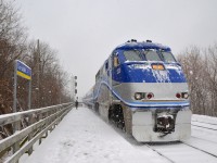 AMT 84 is on time as it arrives at Lasalle Station on the morning of a snowstorm in Montreal with F59PHI AMT 1330 leading.