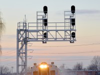 Cab car AMT 708 leads a deadhead move past CP's small Lasalle yard during the morning rush hour.