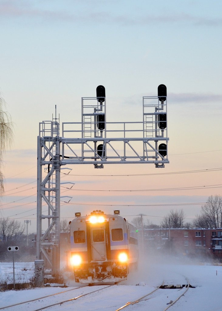 Cab car AMT 708 leads a deadhead move past CP's small Lasalle yard during the morning rush hour.
