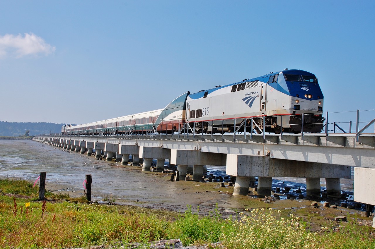 The Amtrak Cascades from Seattle is crossing the new Mud Bay "trestle" behind Amtk 816.