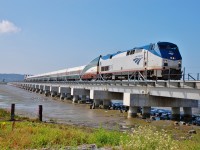 The Amtrak Cascades from Seattle is crossing the new Mud Bay "trestle" behind Amtk 816.