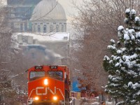 IC 2711 leads CN 149 through old Montreal as it approaches a curve on CN's Wharf Spur the day after a snowstorm.