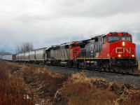 Light rain is falling as this interesting lash-up nears Armstrong with the local mixed freight.