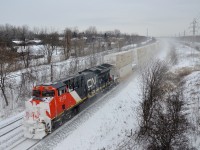Grain train CN 878 has 20 intermodal platforms on the tail end (lifted at Capreol) with snow-covered DPU CN 3113 bringing up the rear.