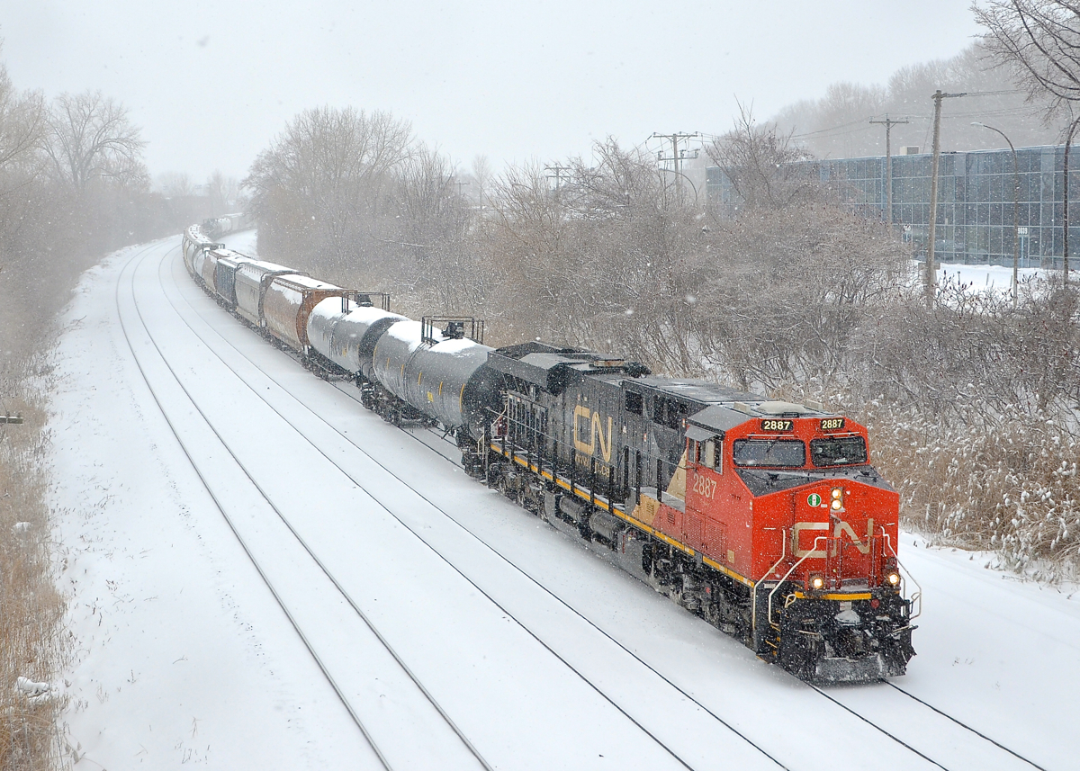 A very late CN 310 is eastbound with CN 2887 at the head end and CN 2654 mid-train.