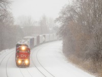 Ex-CNW/UP C40-8 CN 2127 leads CN X324 around a curve on a snowy morning, bound St. Albans, Vermont and interchange with the NECR.