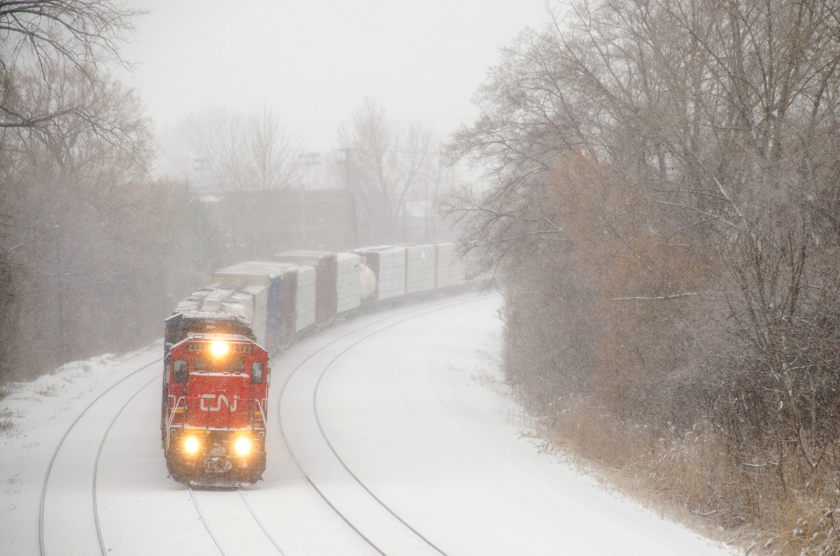 Ex-CNW/UP C40-8 CN 2127 leads CN X324 around a curve on a snowy morning, bound St. Albans, Vermont and interchange with the NECR.