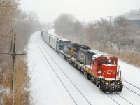 Dash8-40C CN 2127 & Dash8-40CW CSXT 7794 lead CN X324 on a snowy morning with 58 loads and 5 empties for interchange with the NECR in St. Albans, Vermont.