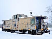 On a snowy Christmas eve, caboose CN 79834 is seen parked in Vankleek Hill on CN's Vankleek Spur. This caboose was built by CN in their Pointe St-Charles shop in Montreal under the same number. CN sold it to the Ontario L'Orignal Railway (OLOR) in 1996, which was taken over by the Ottawa Central Railway. In 2008 CN took over the Ottawa Central and renumbered the caboose back to its CN number. It is used for backup moves on the L'Orignal Spur and is in progressively worse shape.
