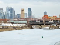A rare daylight CN 528 is crossing the frozen Lachine Canal with NS 9261 & NS 8411 as power. In the background is the skyline of downtown Montreal.