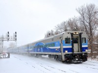 Cab car AMT 706 leads AMT 85 into Lasalle station on a snowy day.