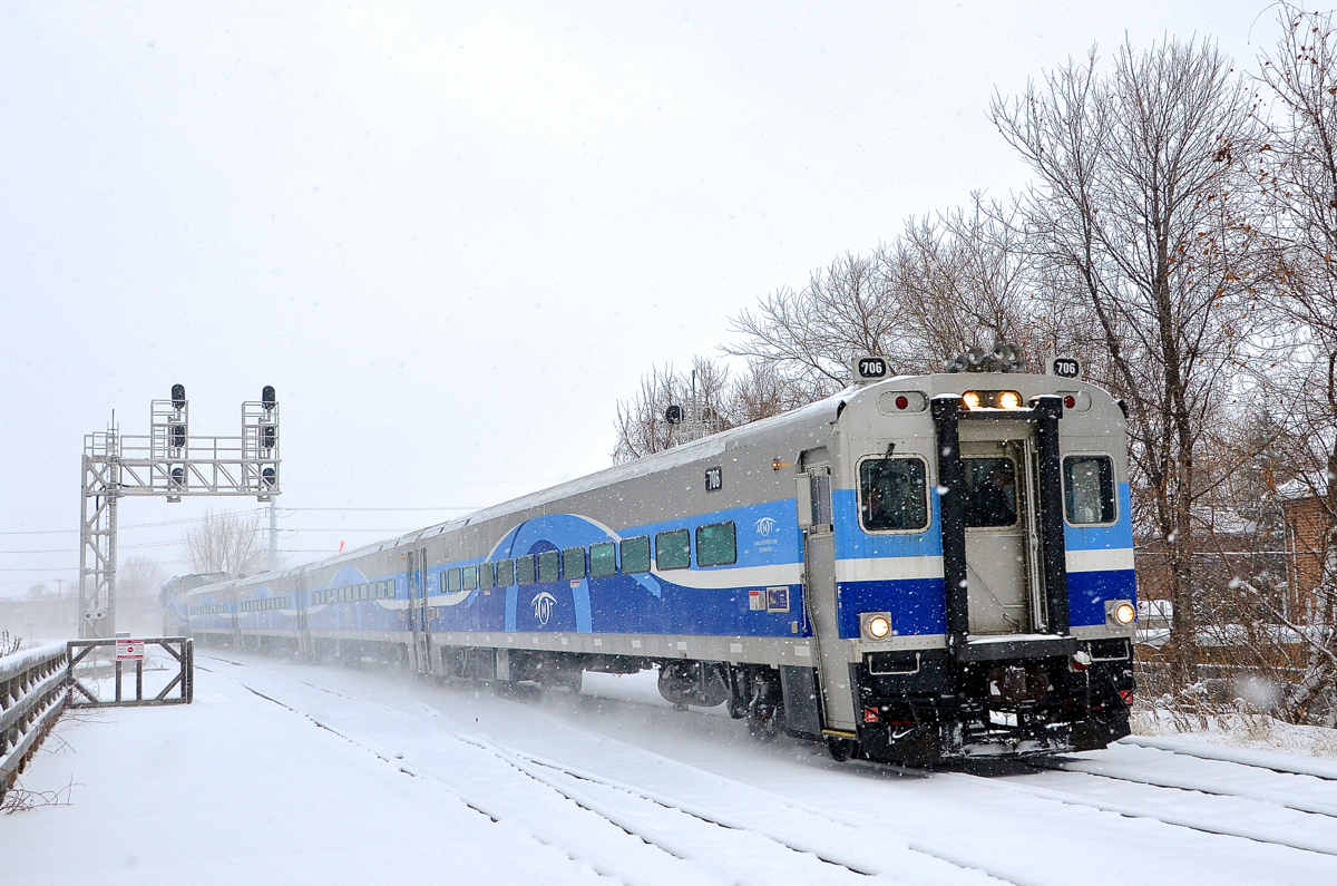 Cab car AMT 706 leads AMT 85 into Lasalle station on a snowy day.