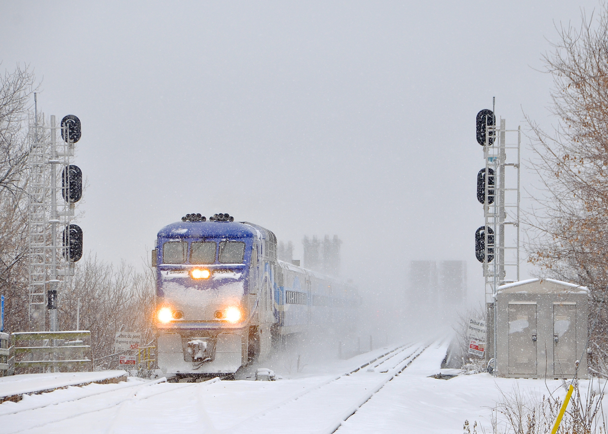 AMT 1327 leads AMT 90 (the mid-day departure from Candiac) onto the island of Montreal on a very snowy day as it approaches Lasalle Station.