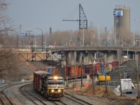 <b>Fairly fresh rebuild leading.</b> SD60E NS 7027 (rebuilt from SD60 NS 6654 in April 2016) is leading CN 529 as it rounds a curve at Turcot West with only 21 cars in tow. Trailing is SD70M-2 NS 2710.
