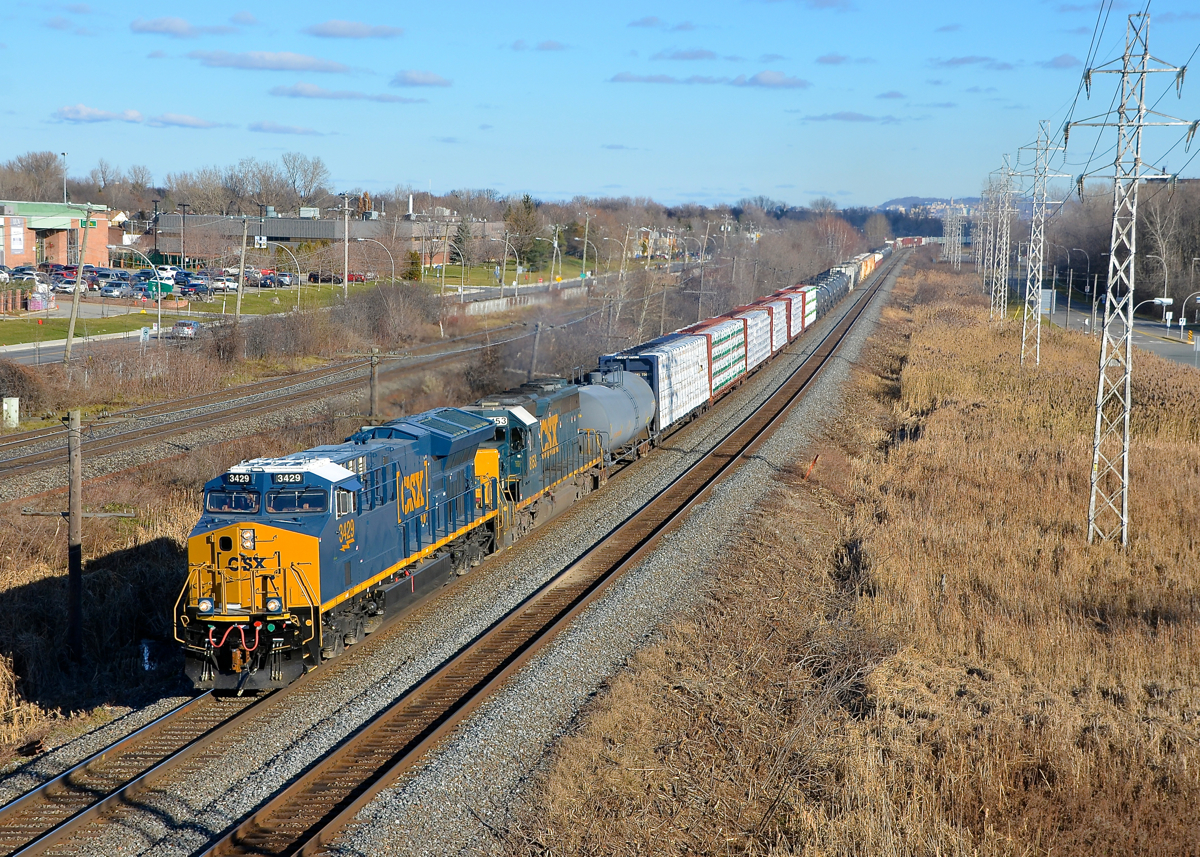 New and old. Nearly brand new ET44AH CSXT 3429 is leading 35-year old SD40-2 CSXT 8153 on CN 327 which is westbound on CN's Kingston Sub on a sunny day (finally, after a week of rain and clouds).