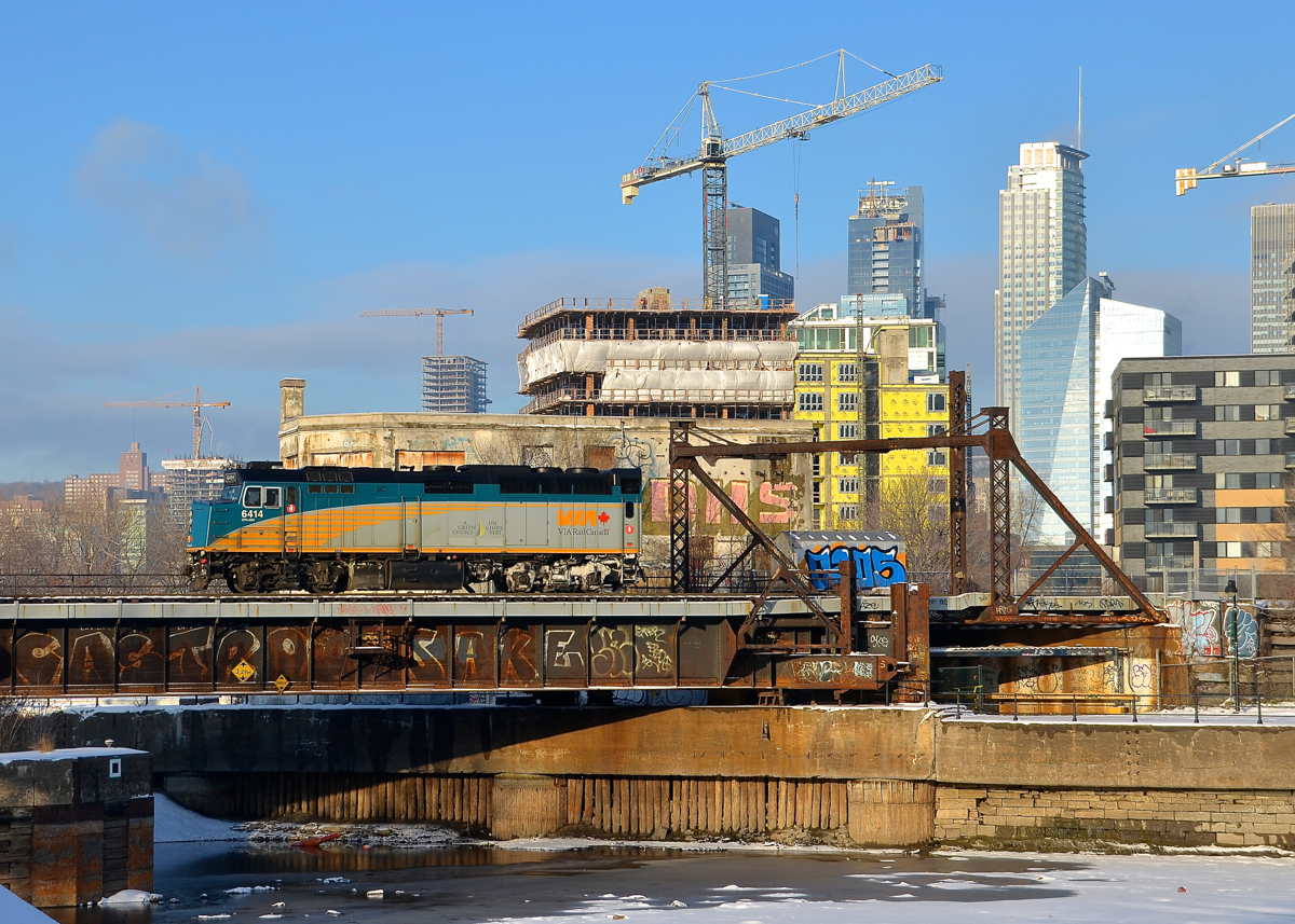 For reasons unknown, VIA 6414 is running light power past Wellington Tower after leaving Montreal's Central Station. It is crossing the Lachine Canal the day after Montreal got a decent amount of snow.