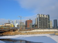 VIA 63 has VIA 6433 leading seven stainless steel cars as it passes Montreal's skyline soon after leaving Central Station.