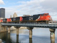 Repainted Dash9-44CWL CN 2502 leads CN 149 over the Lachine Canal, with CN 2012 & IC 2714 leading on a chilly morning.