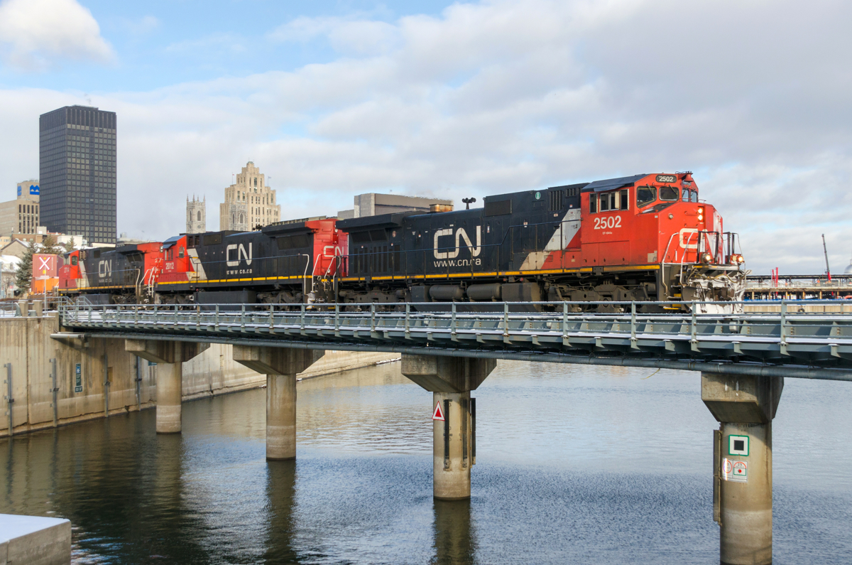 Repainted Dash9-44CWL CN 2502 leads CN 149 over the Lachine Canal, with CN 2012 & IC 2714 leading on a chilly morning.