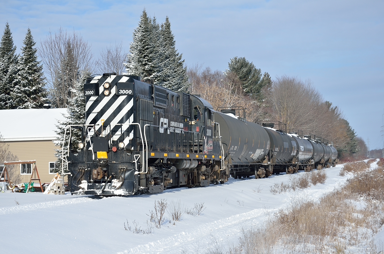 Southbound from its home base in St-Felix-de-Valois, Chemin de Fer de Lanaudière #3000 heads for Joliette and the Quebec Gatineau interchange with six empty propane cars.  The RS-18 is the former SFEX 3000 demonstrator from Eastern Railway Services.