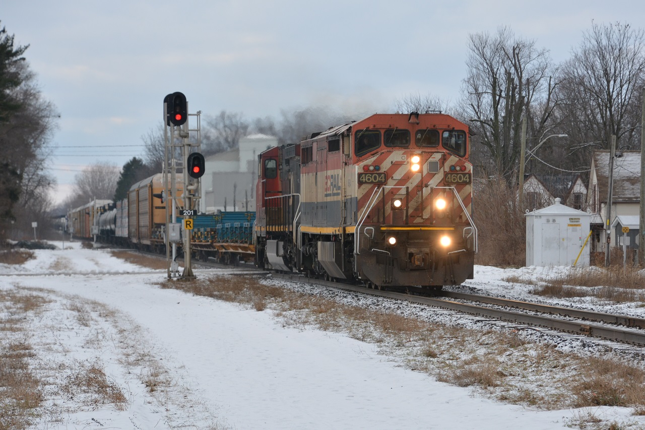 CN L509 approaches the Strathroy VIA station as it blasts through multiple crossings