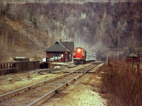 Some days looked a bit too blah to bother going out on. But I usually did. It was nice to be able to drive in and park at Dundas station and keep an eye out for action. This would be a typical dull day scene 35+ years ago, a boring (at the time) CN Tempo train with 3150 leader westbound, but in this case the dullness of the scene to me actually makes the picture. Background is the cliff and Dundas Peak, on the right, the old MoW shed where tools and sometimes track cars were stored. Left of the station is the lead for MoW storage track; at least that what I saw there most of the time. Ballast cars often stored there. The wood railing in the foreground protects workers from slipping off onto Hwy 8 below. Not much else to mention, other than I miss the old station, gone for more than 20 years. Melancholic mood slipping in again.