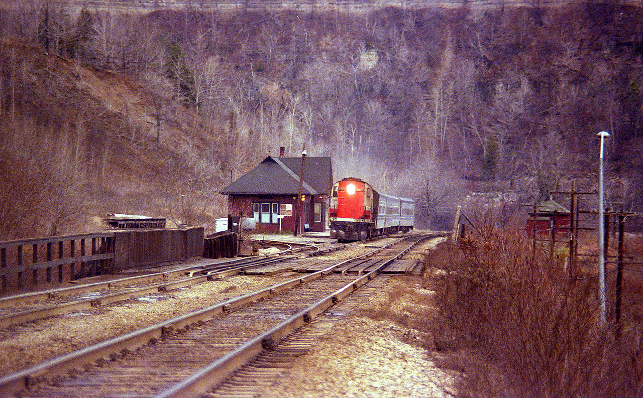 Some days looked a bit too blah to bother going out on. But I usually did. It was nice to be able to drive in and park at Dundas station and keep an eye out for action. This would be a typical dull day scene 35+ years ago, a boring (at the time) CN Tempo train with 3150 leader westbound, but in this case the dullness of the scene to me actually makes the picture. Background is the cliff and Dundas Peak, on the right, the old MoW shed where tools and sometimes track cars were stored. Left of the station is the lead for MoW storage track; at least that what I saw there most of the time. Ballast cars often stored there. The wood railing in the foreground protects workers from slipping off onto Hwy 8 below. Not much else to mention, other than I miss the old station, gone for more than 20 years. Melancholic mood slipping in again.