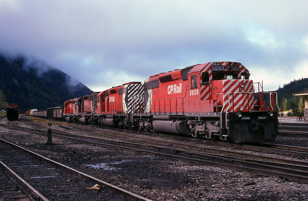 Upon coming across this scene at Field many years ago, I am sure I said to myself "same old stuff" when I viewed this train in the yard with 4 SDs up front. As I look back and then think of what is powering CP out on the system now, I realize how much I miss these old engines. Attractive, really. It is just that there were so many of them..........In this photo you can see the corner of the station at Field at the extreme right, you can see the never-ending low cloud and fog that I take with me on my western travels, and you can see CP 5659, 5567, 5695 and 5729 all ready to be taken eastward. It mystifies me where you western guys find all that sunshine.