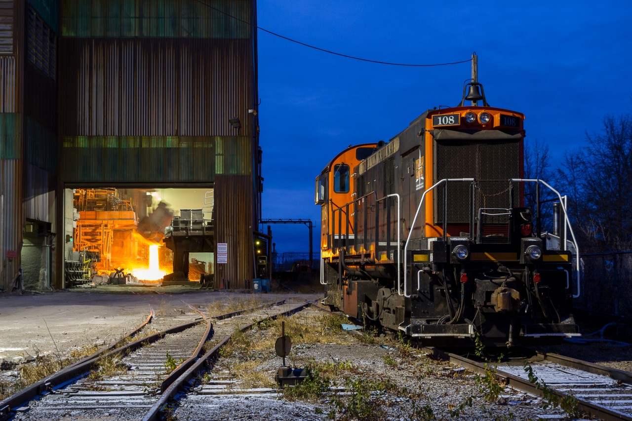 Fire and Ice at Atlas Steel  At 0709 hrs, the belly of the beast at Atlas Steel erupts in a fiery glow - a stark contrast to the cool blue atmosphere of surrounding Welland, Ontario. 

Photograph taken with permission from Atlas Steel and the Trillium Railway.