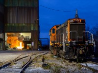 <b>Fire and Ice at Atlas Steel </b> At 0709 hrs, the belly of the beast at Atlas Steel erupts in a fiery glow - a stark contrast to the cool blue atmosphere of surrounding Welland, Ontario. 

Photograph taken with permission from Atlas Steel and the Trillium Railway.