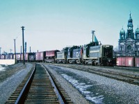 Central Vermont train 444 returning to Italy yard at St. Albans, Vermont, leading the train three EMD SW1200s two Grand Trunk Western numbers 1510 and 1503 and in the middle a Central Vermont No.1500. March 29, 1965.