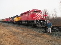 Rather colourful lashup on the head end of this Toronto-bound #521. Appropriate, because engineer Gordie Rivers was not long off retirement, and so he posed (pre-arranged) for his 'official' portrait at the Mile 4 switch at the entrance to the long-gone Montrose Yard. Power is CP 5591, HATX 402, HLCX 3111, CP 4206, 5939, and HATX 401.