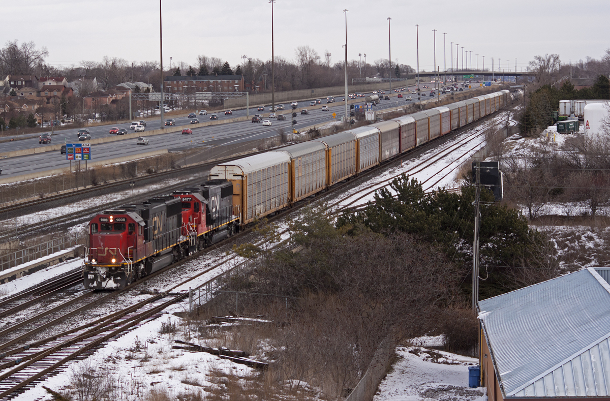CN 373 rolls by Ajax with a pair of standard cabs hauling 4,800' of traffic for Toronto.