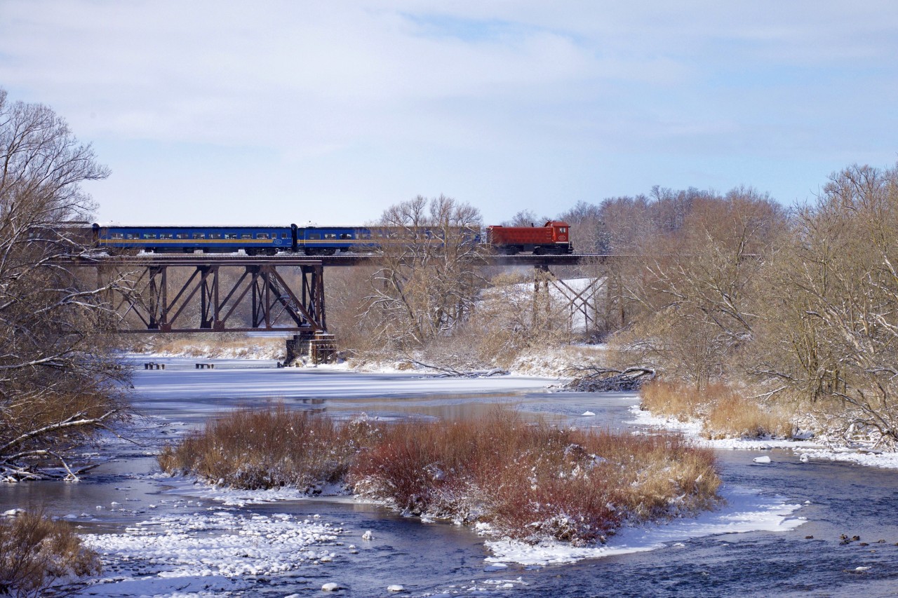 The Waterloo Central Railway "Santa Train" is crossing the bridge over the Conestogo River in St. Jacobs, as it starts its round trip to Elmira and back, on this lovely wintry morning.