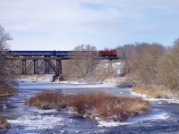 The Waterloo Central Railway "Santa Train" is crossing the bridge over the Conestogo River in St. Jacobs, as it starts its round trip to Elmira and back, on this lovely wintry morning. 