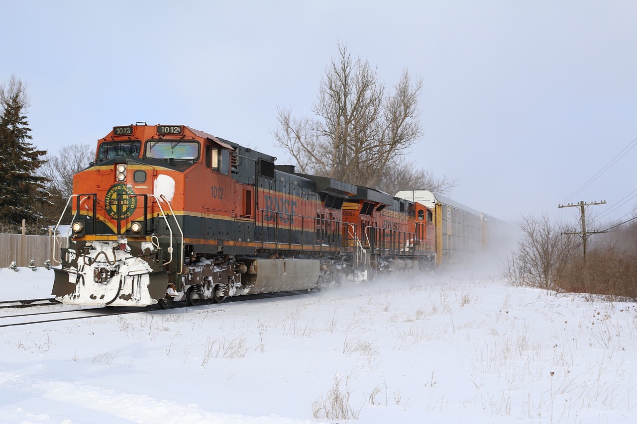 After a full day of chasing OSR's snow plow extra clearing a pair of former CPR lines, catching CN 393 with a pair of BNSF "toasters" was a nice finish to a very successful day. The two foreign units are seen kicking up fresh snow as they storm through the quiet village of Beachville.