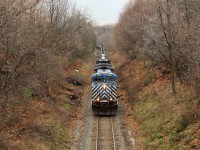 After a lengthy wait for a clearance, CEFX 1020 leads CEFX 1040 up the steep grade past MM 64 and under the Snake road wooden bridge in Waterdown on its way to Guelph Junction.