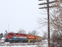 Technology from many decades ago still lingers at Ontario's other Guelph Junction, in Guelph. Not just the aging Geeps but the numerous telephone poles that line the right of way that were once such an essential part of communicating to the outside world. Typically one unit or as of lately the slug set are assigned to train 582 out of Preston, but this day the power typically used by train 580 was assigned to it. The train is in the process of switching from the southern portion of the Fergus sub. to the northern portion as there is no diamond connecting to two sections here. After switching the Guelph north spurs the train will meet up with 580 in the yard to swap crews and cars.